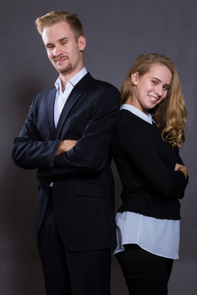 Young beautiful couple studio portrait on grey background. - 写真・画像