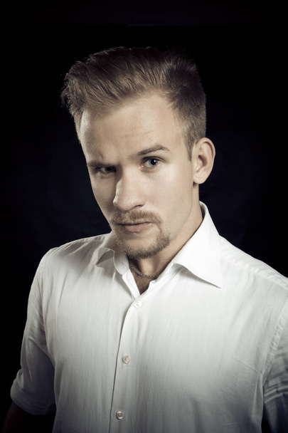 Young man dressed in white shirt studio portrait - Foto, Bild