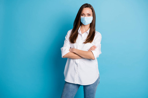 Photo of business lady arms hands crossed good mood wear respirator white shirt jeans isolated blue color background - Foto, Bild
