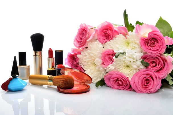 Decorative cosmetics and perfumes subject against a beautiful bouquet of flowers - Photo, Image