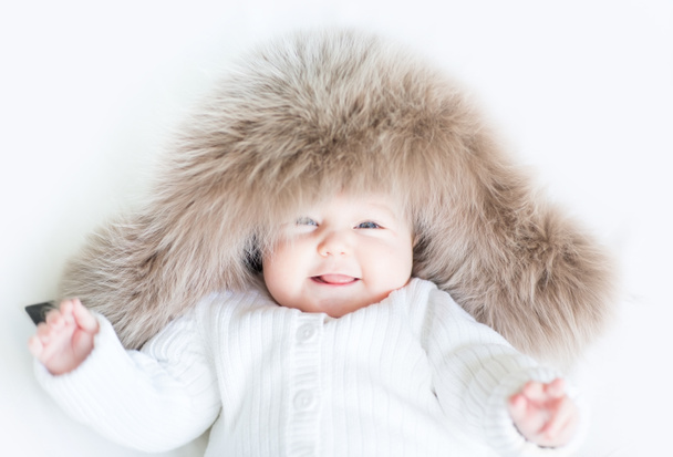 Baby wearing a big fur hat - Photo, Image