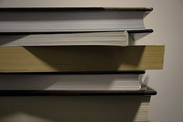 A closeup of a book pile on empty background - Φωτογραφία, εικόνα