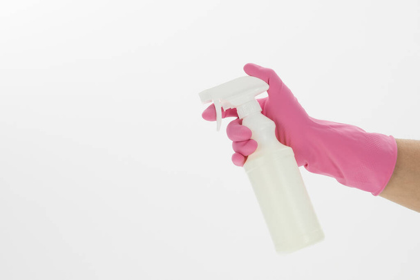 An isolated shot of a hand holding an alcohol spray on a white background - concept COVID19 prevention - Zdjęcie, obraz