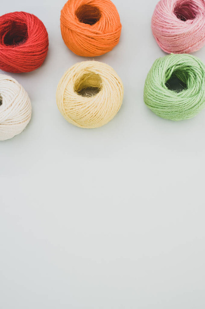 The colorful yarn balls isolated on gray background - Foto, afbeelding