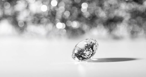 A closeup shot of a beautifully cut diamond on a white surface - Фото, зображення