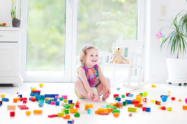 Toddler girl playing with colorful blocks - Photo, Image