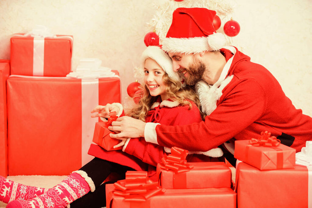 Make your childs holiday extra special this year. Christmas gift for child. Dad in santa costume give gift to daughter cute kid. Happy childhood. Christmas family holiday. Father christmas concept - Valokuva, kuva