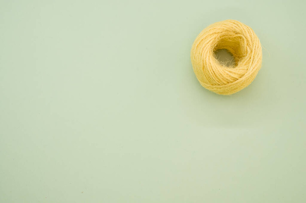 A yellow yarn ball for knitting isolated on gray background - Foto, Imagem