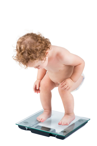 Very funny baby watching her weight - Photo, Image