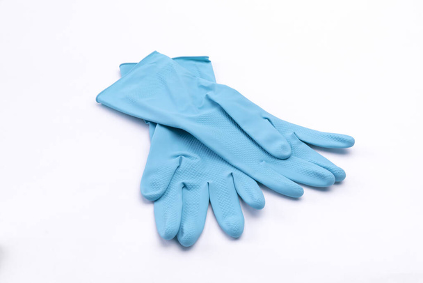 An isolated closeup of blue rubber gloves on a white background - Φωτογραφία, εικόνα