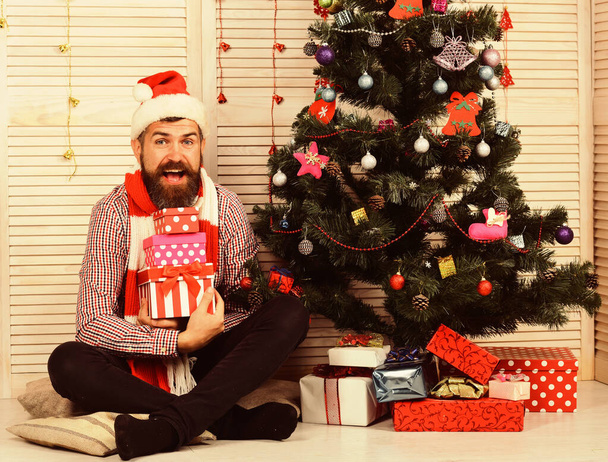 Man with beard holds presents. Santa Claus with excited face - Foto, Imagem