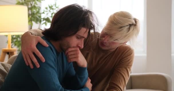 Gay man comforting sad boyfriend at home - Materiał filmowy, wideo