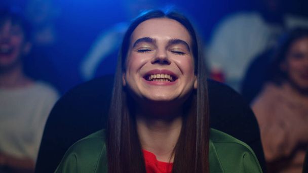 Portrait of smiling woman enjoying funny film in cinema. Girl enjoying comedy - Photo, Image
