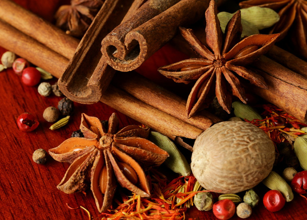 Various spices (nutmeg, cinnamon, star anise, saffron, pepper, cardamom, fennel) - Photo, Image