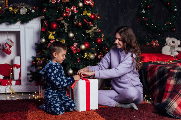 Mãe e menino abrem presentes na decoração da árvore de Natal ano novo - Foto, Imagem