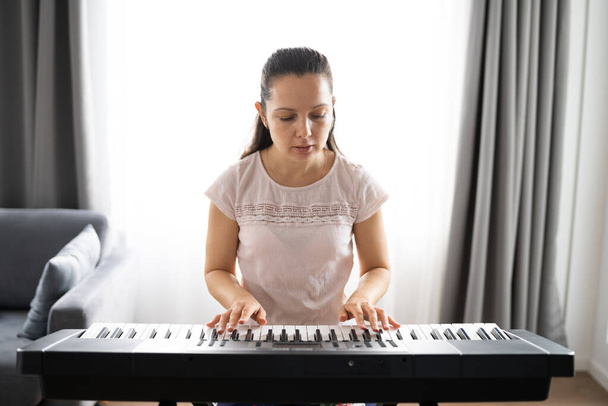 Woman Playing Music Keyboard Piano Instrument At Home - Fotografie, Obrázek