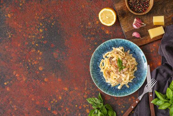 Plate of tasty pasta with chicken on table - Photo, image