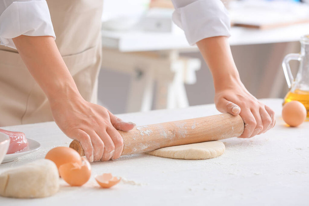 Woman making raw pasta in kitchen, closeup - 写真・画像