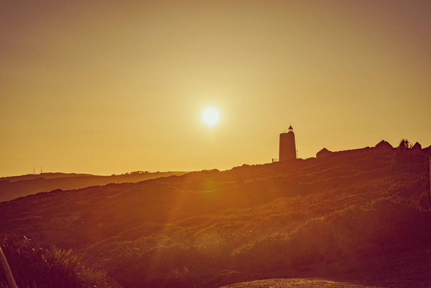 Carbonera Lighthouse located on Punta Mala, La Alcaidesa, Spain. Lantern overlooks the Strait of Gibraltar. Sunset view - Fotó, kép