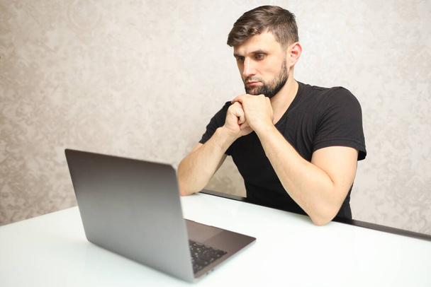 a man working on a laptop at home in quarantine - Fotó, kép