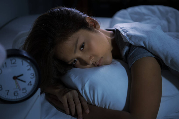 Depressed young woman lying in bed cannot sleep from insomnia - Photo, Image