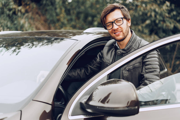 Stylish man in glasses sits in a car - Fotografie, Obrázek