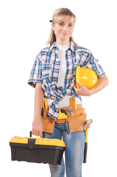 Female wearing working clothes with toolbelt holding hardhat - Foto, Imagen