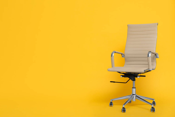 Modern office chair on yellow background. Space for text - Фото, зображення