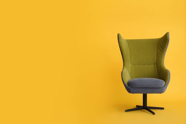 Modern office chair on yellow background. Space for text - Φωτογραφία, εικόνα