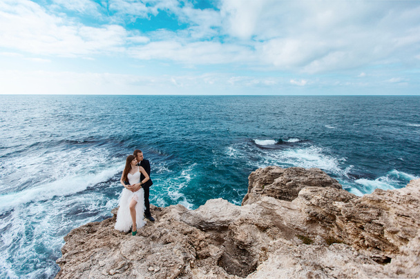 Bride and groom near the ocean - 写真・画像