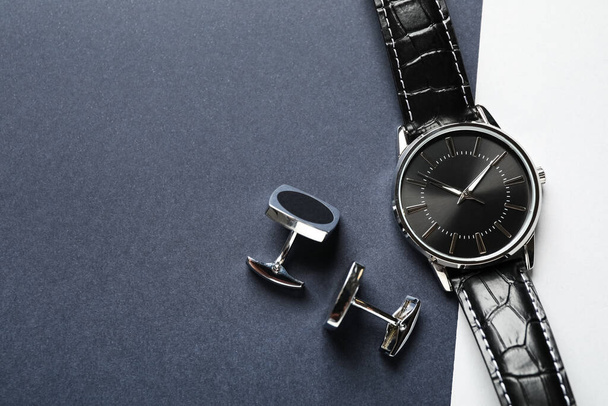 Luxury wrist watch and cufflinks on color background, flat lay. Space for text - Fotoğraf, Görsel