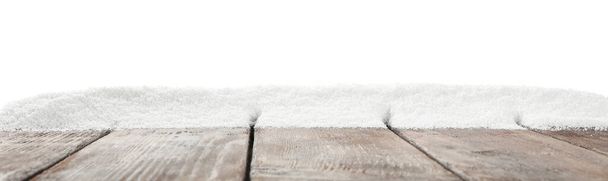 Artificial snow on wooden table against white background. Christmas decor - 写真・画像