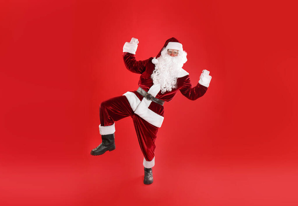 Full length portrait of Santa Claus on red background - Photo, image