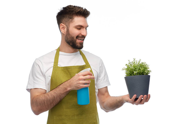 happy smiling male gardener moisturizing flower - 写真・画像