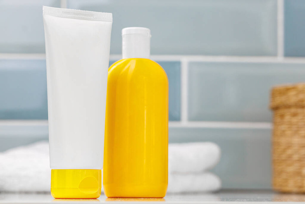 Sunscreen cosmetic containers in bathroom close up - Фото, зображення