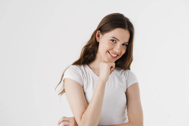 Красивая молодая улыбающаяся женщина в повседневной одежде на белом фоне - Фото, изображение