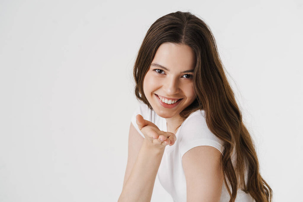 Pretty young smiling woman wearing casual clothes isolated over white background, blowing kiss - Φωτογραφία, εικόνα