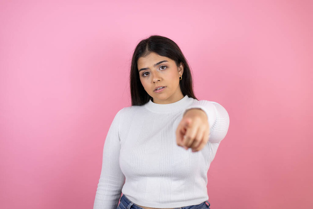 Young beautiful woman over isolated pink background pointing to the front with finger - Photo, Image
