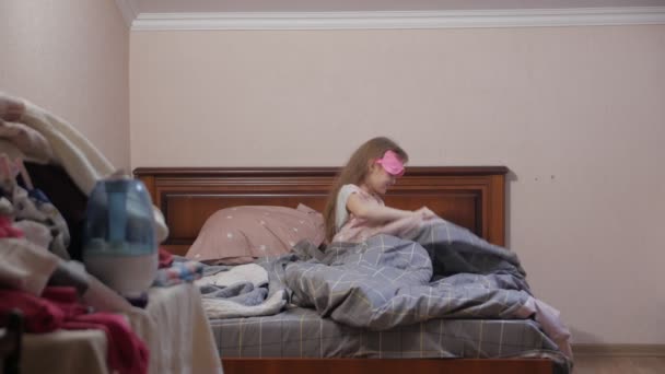 Маленька дівчинка прокидається і покриває ліжко
 - Кадри, відео
