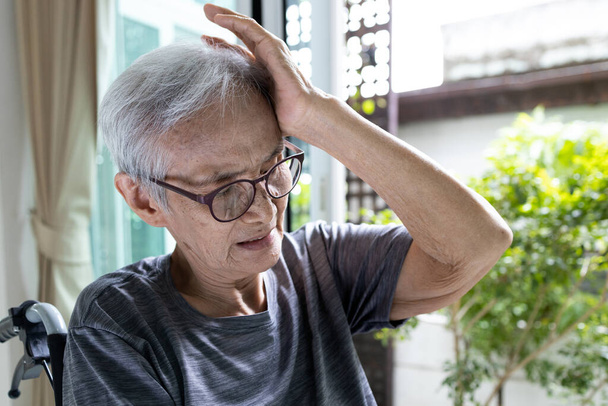 Stanco esausto asiatico anziana donna affetta da emicrania mal di testa, vecchio anziano che tiene la testa con la mano, si sente vertigini, perdita di equilibrio o barcollare, sintomi di vertigini, stupore, vicino all'incoscienza - Foto, immagini
