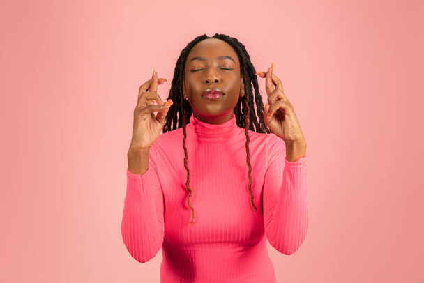 Young emotional african-american woman isolated on pink studio background, facial expression. Half-lenght portrait with copyspace. - Foto, imagen