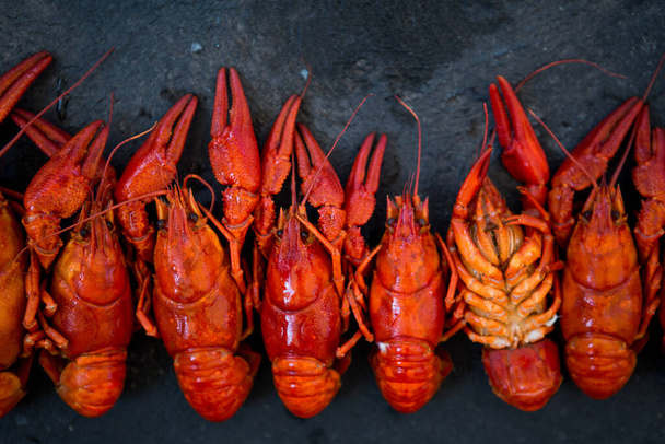 Red boiled crawfishes on table in rustic style, closeup. Lobster closeup. - Foto, imagen