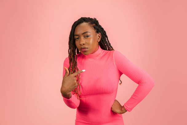 Portrait of young african-american woman isolated on pink studio background, facial expression. Beautiful female half-lenght portrait with copyspace. - Fotó, kép