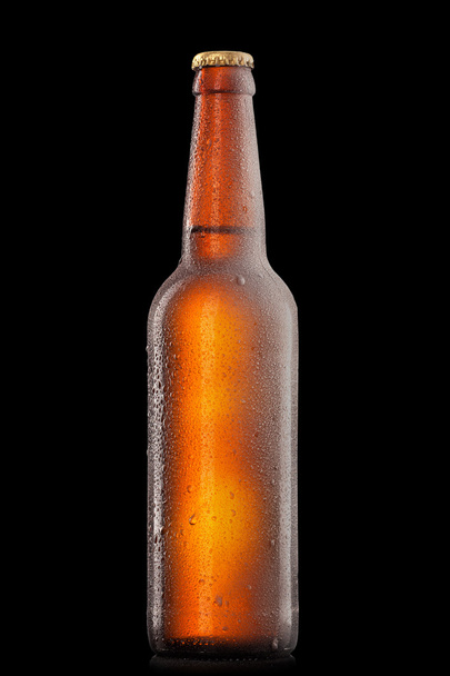 Beer bottle with water drops and frost isolated on black - Foto, imagen