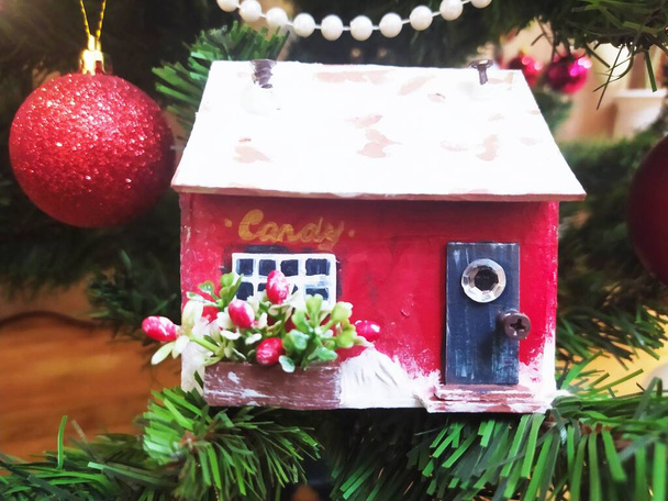 Red christmas house made of cardboard. New year decoration. Miniature of candy shop - Photo, Image