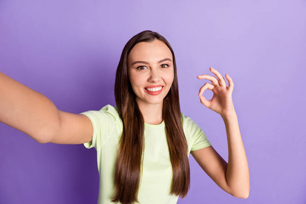Portrait of charming lady show fingers okey symbol approval make selfie isolated on pastel purple color background - Zdjęcie, obraz