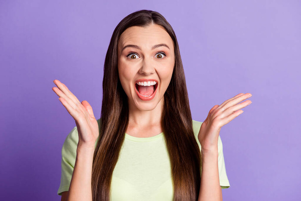 Photo of attractive lady arms palm open mouth scream yeah light green outfit isolated on violet color background - Valokuva, kuva