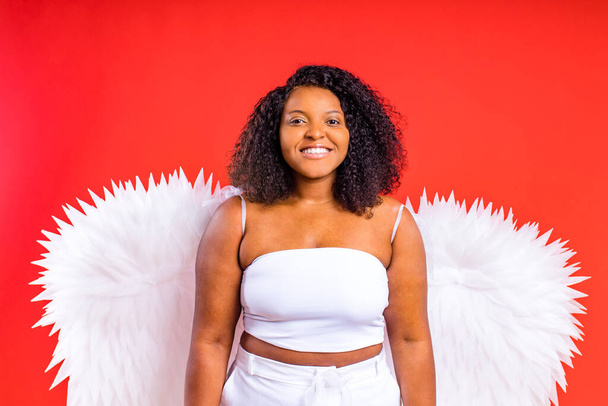 spain cheerful angel with wings on red background studio - 写真・画像