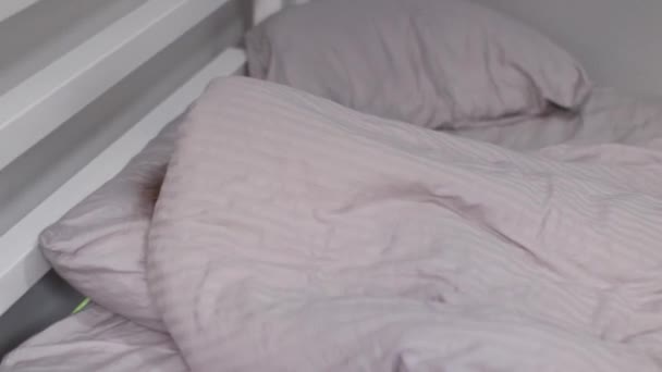 pretty little blonde girl playing hide and seek on gray bed. laughing, having fun. morning routine, childhood, toddler, daughter. FullHD footage - Footage, Video