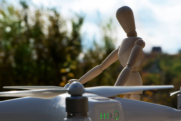 The AI serviceman doll is working on his drone. Checking testing gear before flying. - Photo, Image